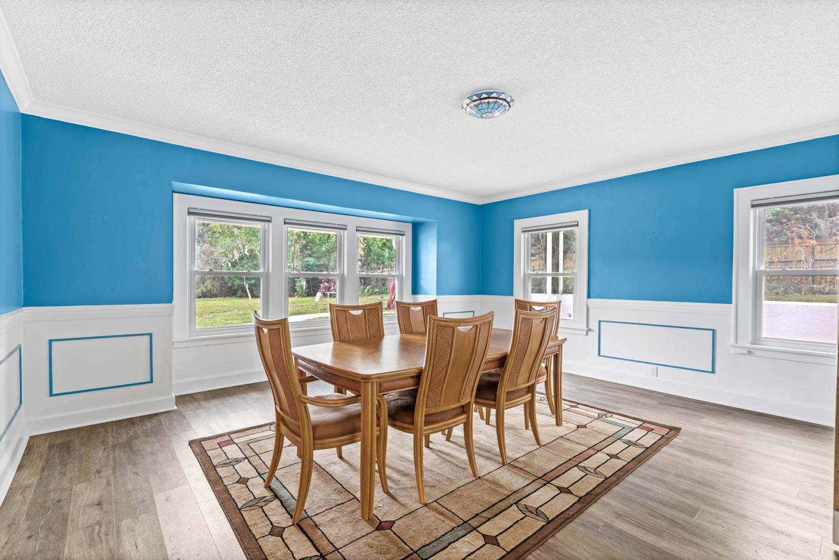 dining room with blue walls and table with chairs